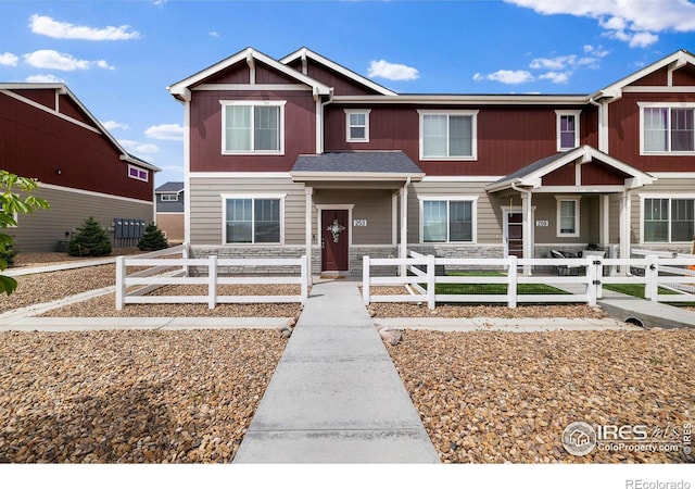 253 Molinar St, Johnstown, CO 80534 - view of property with stone siding and a fenced front yard