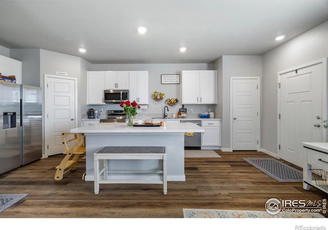253 Molinar St, Johnstown, CO 80534 - kitchen featuring appliances with stainless steel finishes, a sink, white cabinetry, light countertops, and recessed lighting