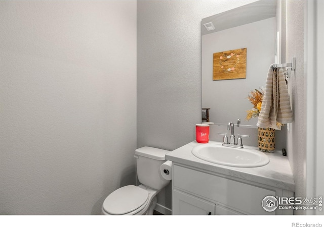 253 Molinar St, Johnstown, CO 80534 - bathroom featuring vanity, toilet, and a textured wall