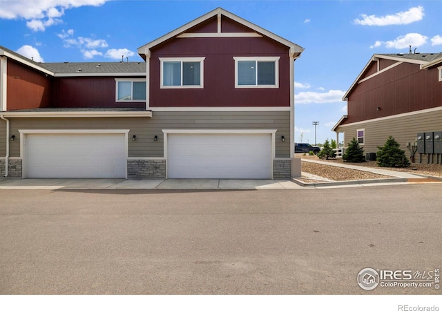 253 Molinar St, Johnstown, CO 80534 - view of front of property featuring stone siding and an attached garage