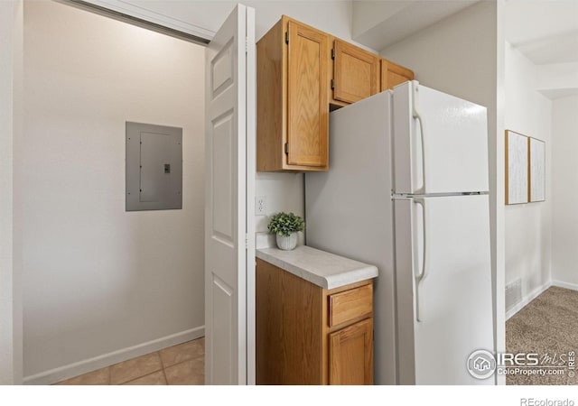 4545 Wheaton Dr Unit A-290, Fort Collins, CO 80525 - kitchen with electric panel, freestanding refrigerator, light countertops, and baseboards