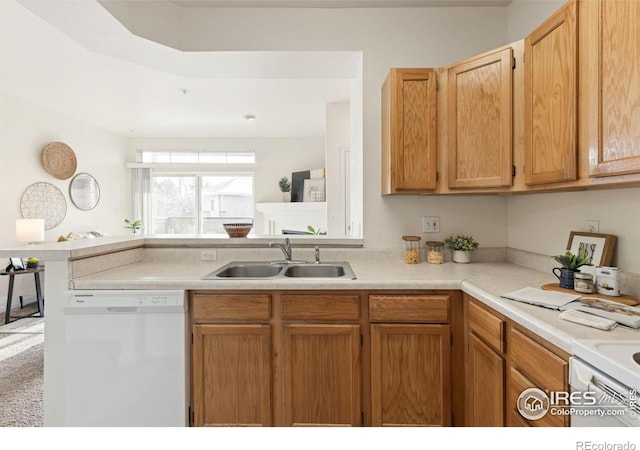 4545 Wheaton Dr Unit A-290, Fort Collins, CO 80525 - kitchen featuring white appliances, a sink, light countertops, and a peninsula