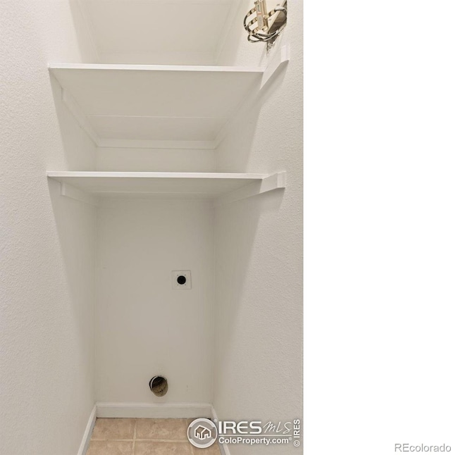 4545 Wheaton Dr Unit A-290, Fort Collins, CO 80525 - laundry area with electric dryer hookup, baseboards, and light tile patterned floors
