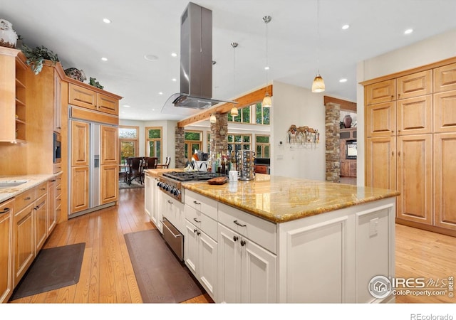 5025 Eagle Lake Dr, Fort Collins, CO 80524 - kitchen with island range hood, paneled refrigerator, gas cooktop, light wood-type flooring, and a center island