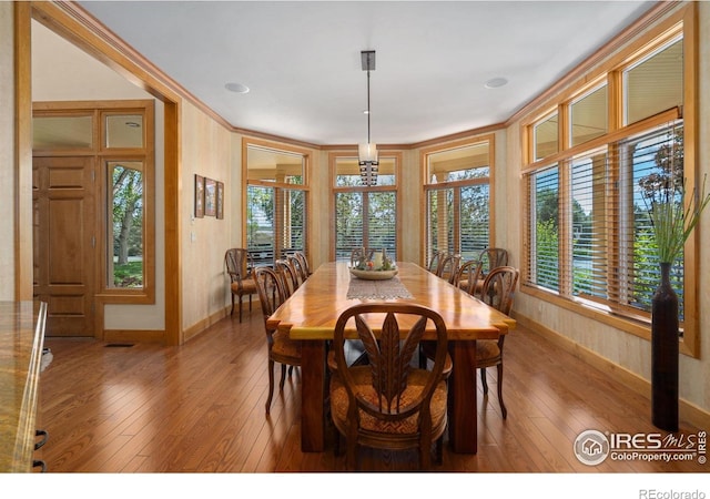 5025 Eagle Lake Dr, Fort Collins, CO 80524 - dining area featuring baseboards, hardwood / wood-style flooring, plenty of natural light, and ornamental molding