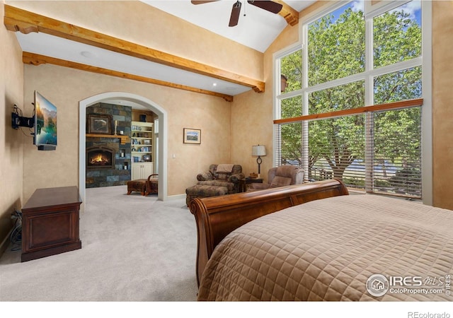 5025 Eagle Lake Dr, Fort Collins, CO 80524 - bedroom featuring carpet, a lit fireplace, and arched walkways