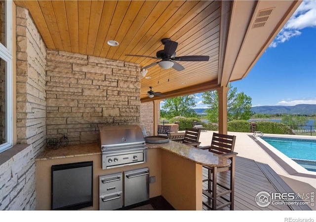 5025 Eagle Lake Dr, Fort Collins, CO 80524 - view of patio featuring a mountain view, an outdoor bar, and ceiling fan