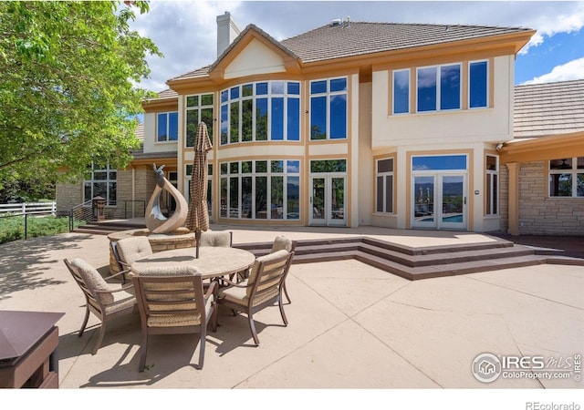 5025 Eagle Lake Dr, Fort Collins, CO 80524 - back of house with french doors, a patio, a chimney, and a tile roof