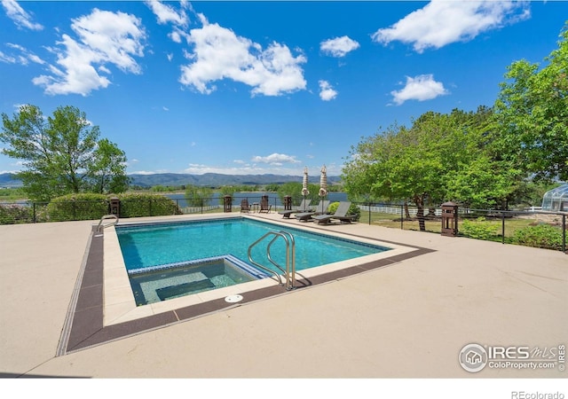 5025 Eagle Lake Dr, Fort Collins, CO 80524 - view of swimming pool featuring an in-ground hot tub, a patio area, and a mountain view
