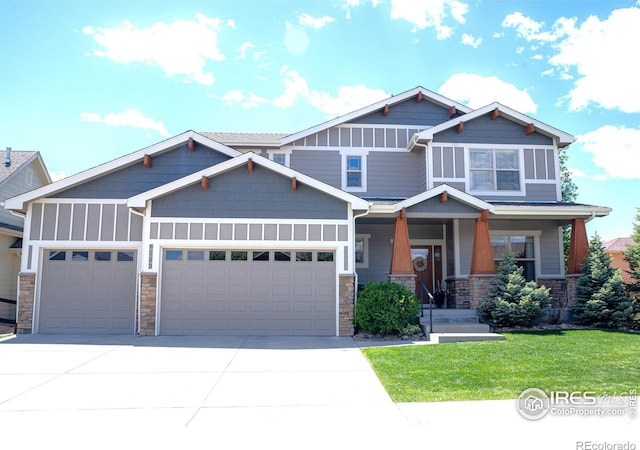 6523 Spanish Bay Dr, Windsor, CO 80550 - craftsman inspired home featuring an attached garage, stone siding, driveway, and a front lawn