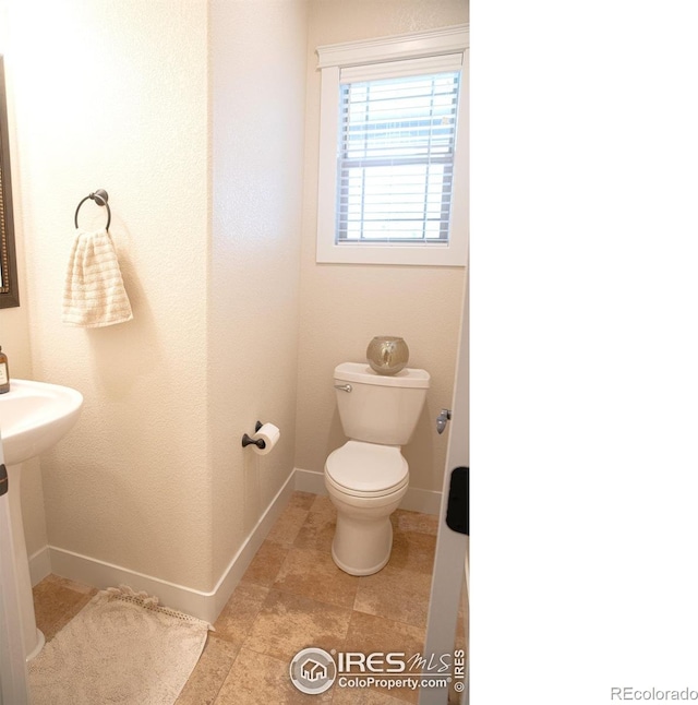 6523 Spanish Bay Dr, Windsor, CO 80550 - half bath featuring toilet and baseboards