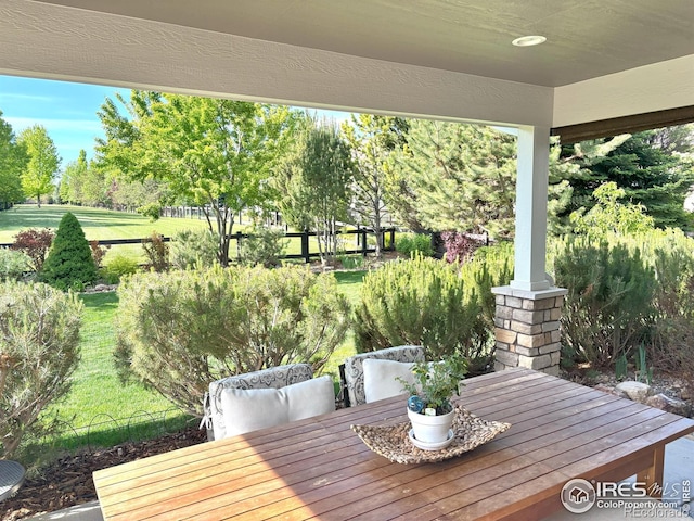 6523 Spanish Bay Dr, Windsor, CO 80550 - view of patio featuring view of wooded area and outdoor dining space