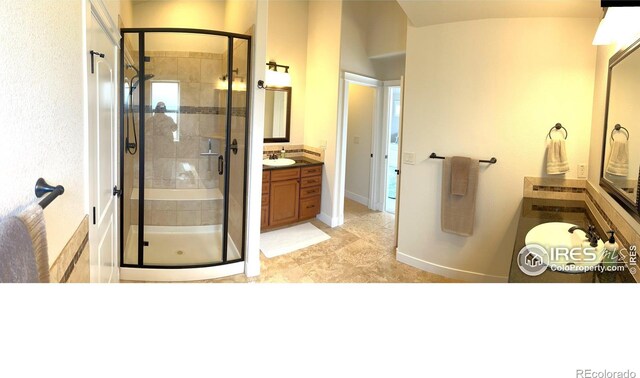 6523 Spanish Bay Dr, Windsor, CO 80550 - bathroom featuring a stall shower, vanity, and baseboards