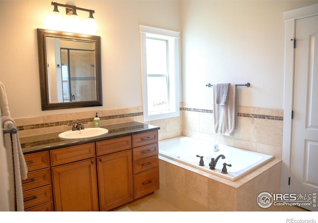 6523 Spanish Bay Dr, Windsor, CO 80550 - full bathroom with a garden tub, vanity, and a shower