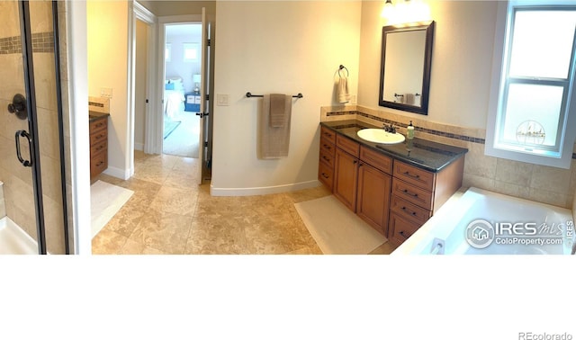 6523 Spanish Bay Dr, Windsor, CO 80550 - full bath featuring vanity, a stall shower, a bathtub, baseboards, and tile patterned floors