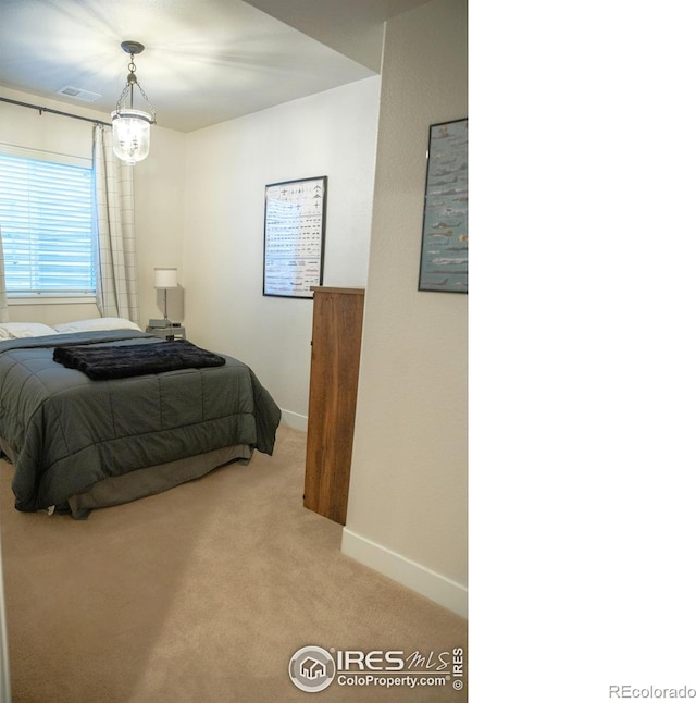 6523 Spanish Bay Dr, Windsor, CO 80550 - bedroom featuring light carpet, a chandelier, and baseboards