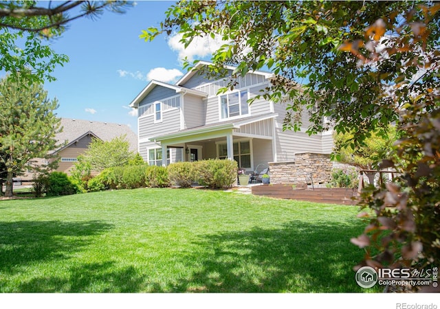 6523 Spanish Bay Dr, Windsor, CO 80550 - rear view of property featuring a yard and board and batten siding