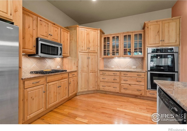 6535 Half Moon Bay Dr, Windsor, CO 80550 - kitchen with stainless steel appliances, light brown cabinets, light wood-type flooring, and glass insert cabinets
