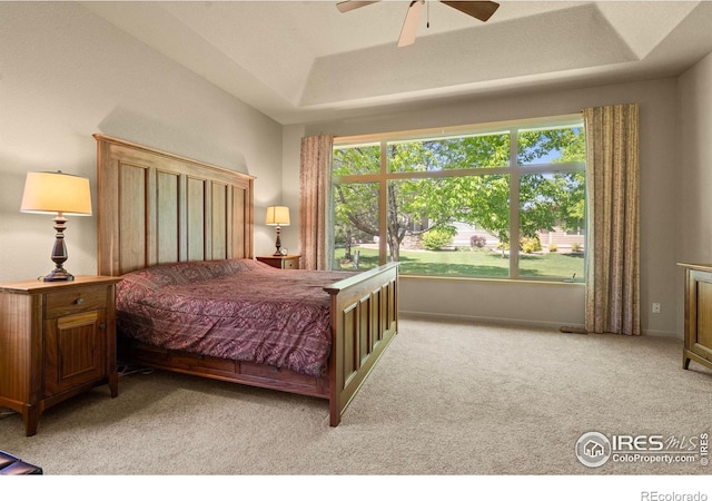 6535 Half Moon Bay Dr, Windsor, CO 80550 - bedroom with a tray ceiling, light carpet, and a ceiling fan