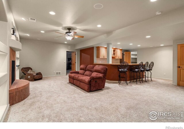 6535 Half Moon Bay Dr, Windsor, CO 80550 - living area with light carpet, a bar, recessed lighting, and baseboards