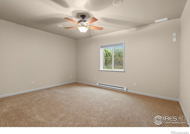 6535 Half Moon Bay Dr, Windsor, CO 80550 - unfurnished room featuring a baseboard heating unit, carpet, a ceiling fan, and baseboards