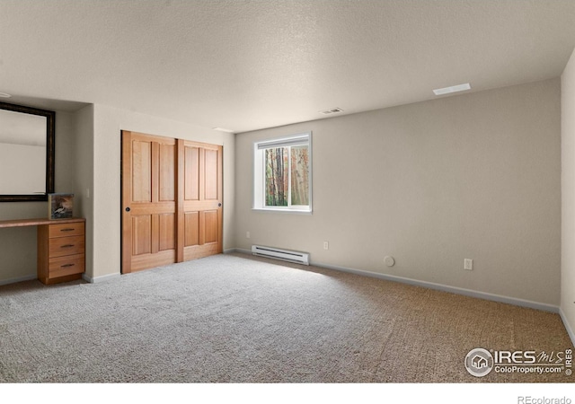 6535 Half Moon Bay Dr, Windsor, CO 80550 - unfurnished bedroom featuring a baseboard radiator, carpet flooring, baseboards, a textured ceiling, and a closet