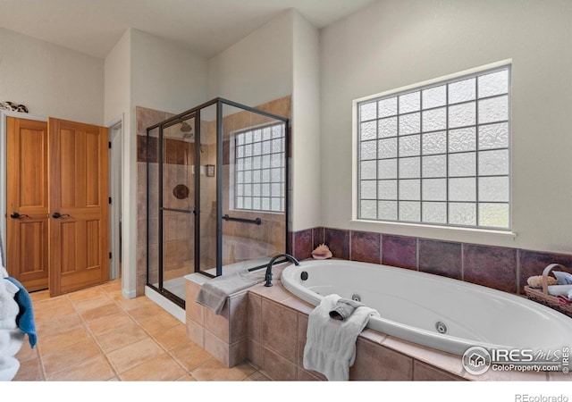 6535 Half Moon Bay Dr, Windsor, CO 80550 - full bath featuring a stall shower, a tub with jets, and tile patterned flooring