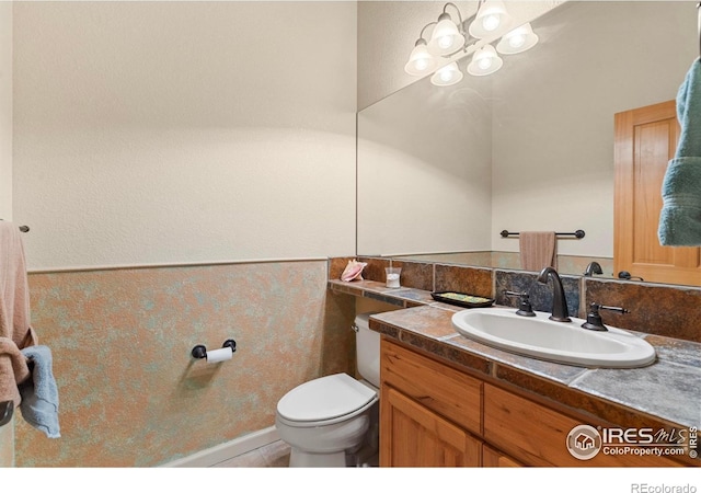 6535 Half Moon Bay Dr, Windsor, CO 80550 - half bath with vanity, toilet, and a chandelier