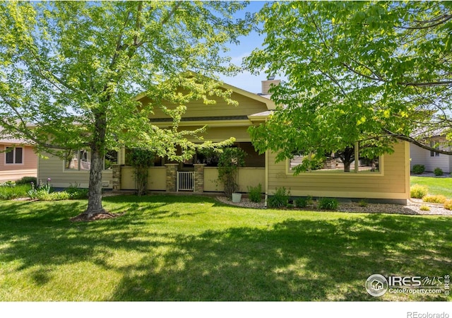6535 Half Moon Bay Dr, Windsor, CO 80550 - view of front of property with a front lawn and a chimney