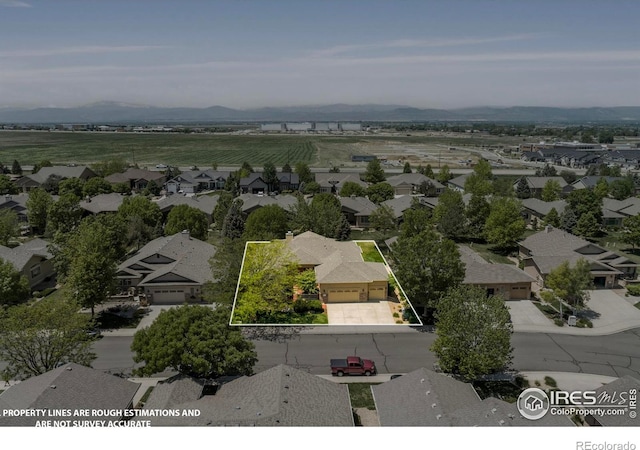6535 Half Moon Bay Dr, Windsor, CO 80550 - aerial perspective of suburban area featuring property boundaries highlighted and a mountain backdrop
