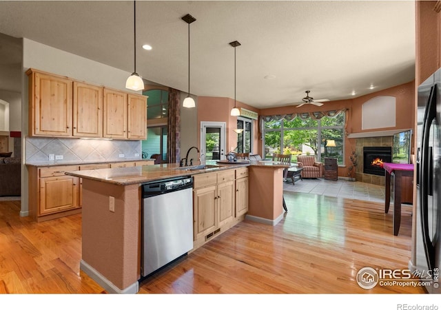 6535 Half Moon Bay Dr, Windsor, CO 80550 - kitchen with dishwasher, light wood-style flooring, open floor plan, light brown cabinets, and recessed lighting