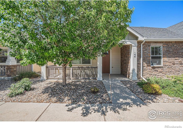 4751 Pleasant Oak Dr Unit B44, Fort Collins, CO 80525 - view of front facade featuring covered porch, stone siding, and roof with shingles