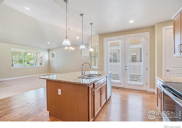 4751 Pleasant Oak Dr Unit B44, Fort Collins, CO 80525 - kitchen featuring a sink, light wood-style flooring, appliances with stainless steel finishes, brown cabinets, and light stone counters