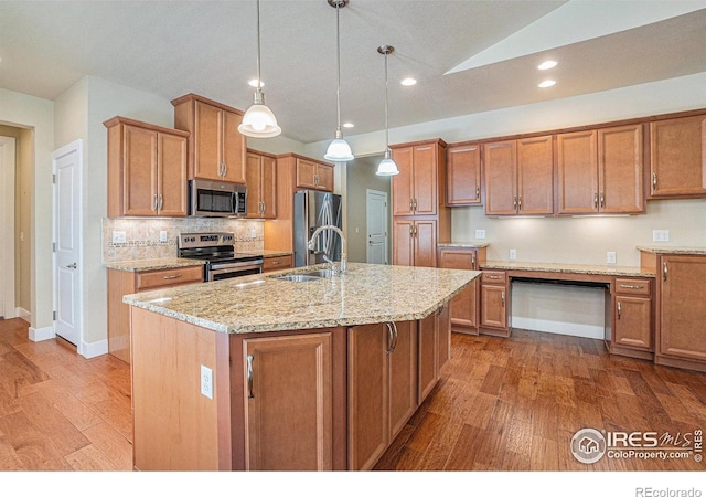 4751 Pleasant Oak Dr Unit B44, Fort Collins, CO 80525 - kitchen with appliances with stainless steel finishes, a sink, hardwood / wood-style flooring, light stone countertops, and an island with sink