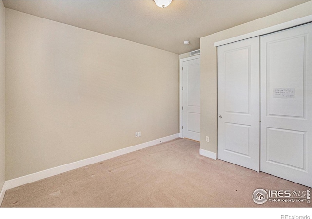 4751 Pleasant Oak Dr Unit B44, Fort Collins, CO 80525 - unfurnished bedroom with light colored carpet, baseboards, and a closet