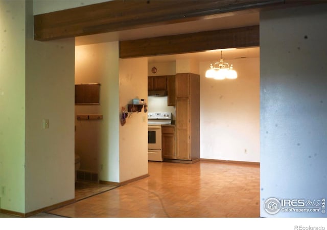 50 19th Ave Unit 9, Longmont, CO 80501 - kitchen with white electric stove, a chandelier, brown cabinetry, under cabinet range hood, and baseboards