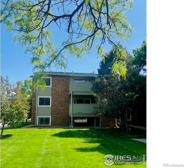 50 19th Ave Unit 9, Longmont, CO 80501 - back of property featuring a lawn and brick siding
