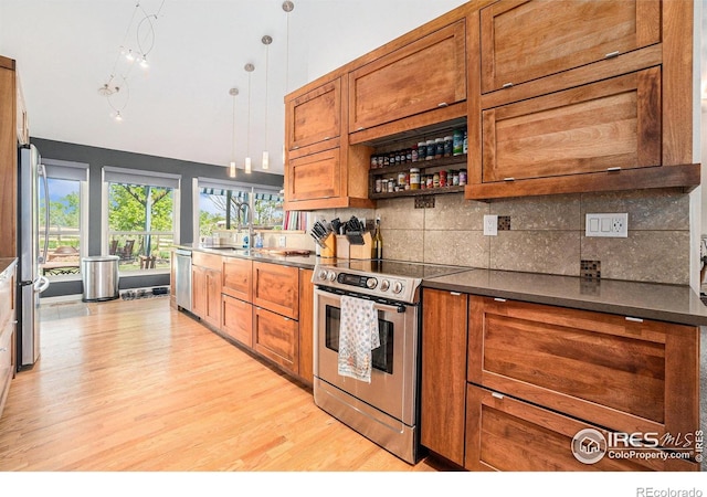 3412 Erving Ct, Berthoud, CO 80513 - kitchen featuring stainless steel appliances, brown cabinetry, light wood-type flooring, and decorative backsplash