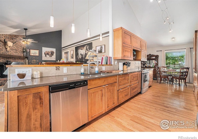 3412 Erving Ct, Berthoud, CO 80513 - kitchen with stainless steel appliances, light wood finished floors, a sink, decorative light fixtures, and brown cabinets