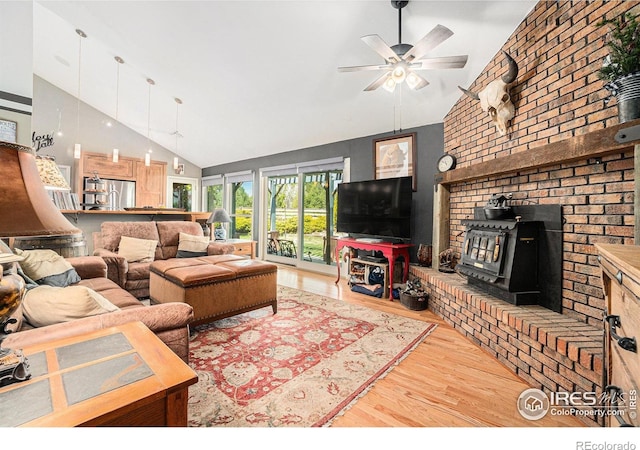3412 Erving Ct, Berthoud, CO 80513 - living area with a wood stove, wood finished floors, a ceiling fan, and high vaulted ceiling