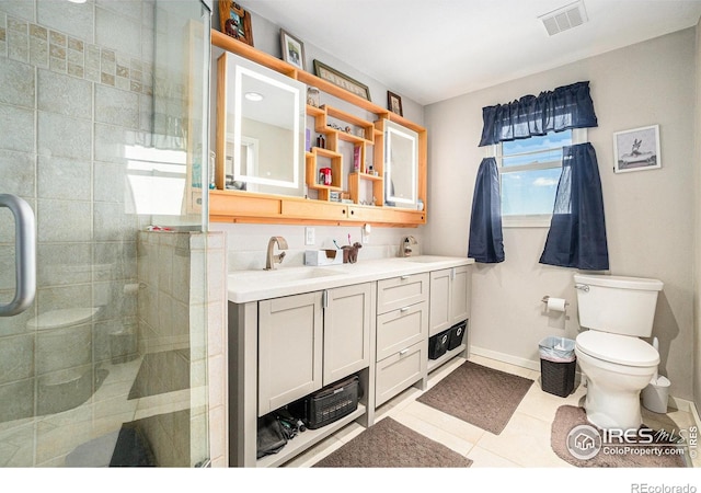 3412 Erving Ct, Berthoud, CO 80513 - full bath featuring toilet, double vanity, a shower stall, baseboards, and tile patterned floors