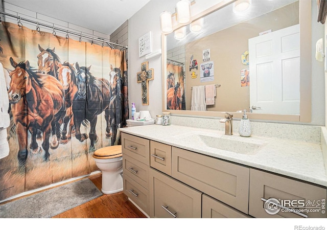 3412 Erving Ct, Berthoud, CO 80513 - bathroom with wood finished floors, vanity, toilet, and a shower with curtain