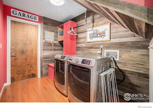 3412 Erving Ct, Berthoud, CO 80513 - laundry room featuring wood walls, washer and dryer, and light wood finished floors