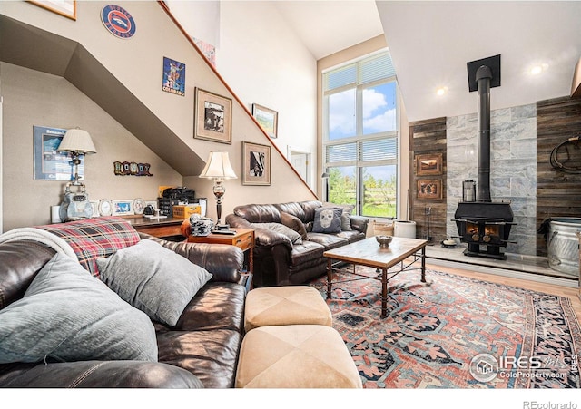 3412 Erving Ct, Berthoud, CO 80513 - living room with a wood stove, high vaulted ceiling, and wood finished floors