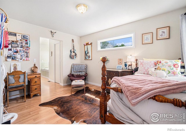 3412 Erving Ct, Berthoud, CO 80513 - bedroom with wood finished floors, ensuite bath, and baseboards