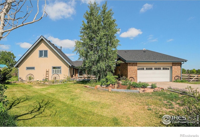 3412 Erving Ct, Berthoud, CO 80513 - view of front of home with driveway, a garage, and brick siding