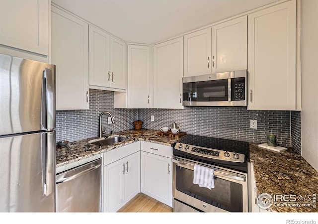 855 W Moorhead Cir Unit C, Boulder, CO 80305 - kitchen featuring stainless steel appliances, a sink, white cabinetry, and backsplash