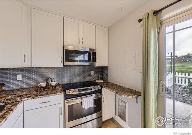 855 W Moorhead Cir Unit C, Boulder, CO 80305 - kitchen with stainless steel appliances, backsplash, white cabinets, and dark stone counters
