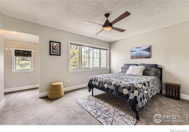 855 W Moorhead Cir Unit C, Boulder, CO 80305 - bedroom with multiple windows, carpet flooring, baseboards, a textured ceiling, and ceiling fan