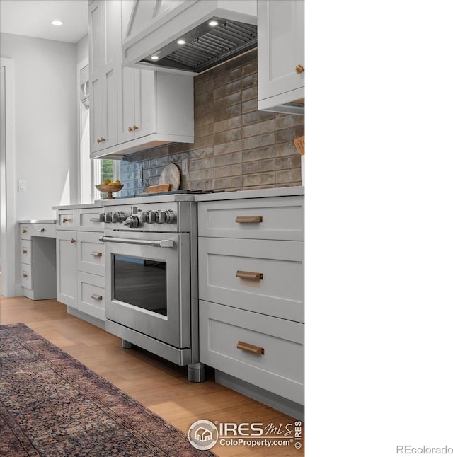 3256 S Corona St, Englewood, CO 80113 - kitchen featuring premium range hood, decorative backsplash, light wood-type flooring, high end range, and recessed lighting